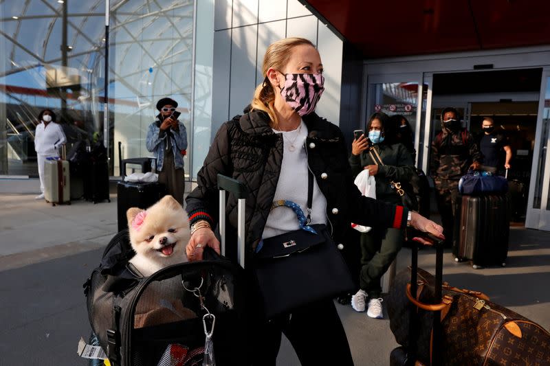 Stephanie Anderson and her companion, Gypsy, of Los Angeles, wait to depart Hartsfield-Jackson Atlanta International Airport ahead of the Thanksgiving holiday