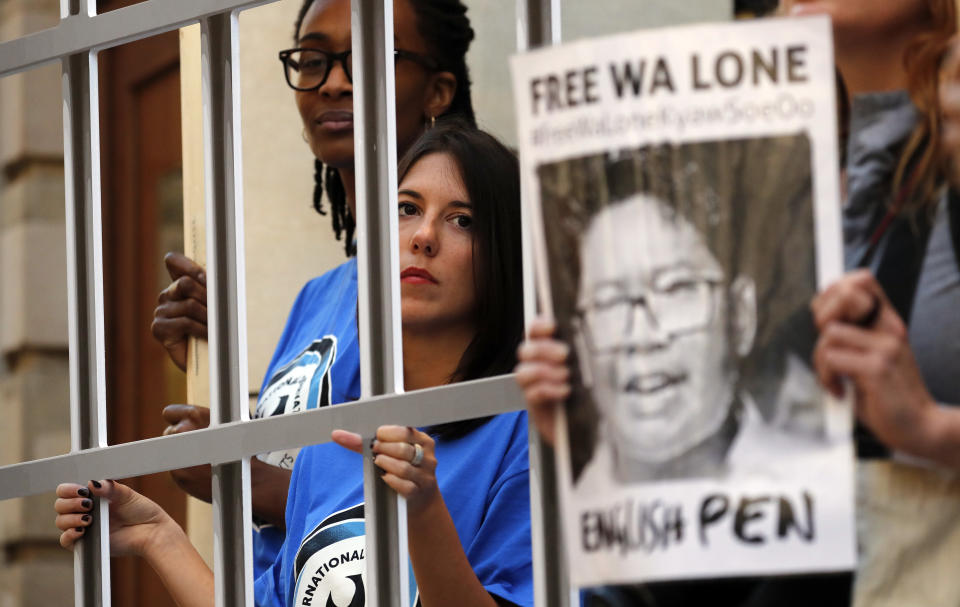 Protestors demonstrate by holding a symbolic fence in front of the Myanmar Embassy to petition for the release of Reuters journalists Wa Lone and Kyaw Soe Oo in London, Thursday, Sept. 27, 2018. The journalists were given a seven-year prison sentence Sept. 3, in Myanmar, jailed on charges of possessing state secrets in connection with their reporting about massacres of Rohingya Muslims.(AP Photo/Frank Augstein)
