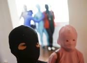 Masaru Morisako (L), a nine-year-old Japanese boy, poses for photos with another child participant in Zentai costumes, or skin-tight bodysuits from head to toe, before a march down the shopping district of Orchard Road during Zentai Art Festival in Singapore May 23, 2015. Close to 50 participants strutted down the busy shopping district during the Zentai art festival which is jointly organized by the Japanese embassy. The festival includes performances and discussions on Zentai from May 22 to from June 5. REUTERS/Edgar Su