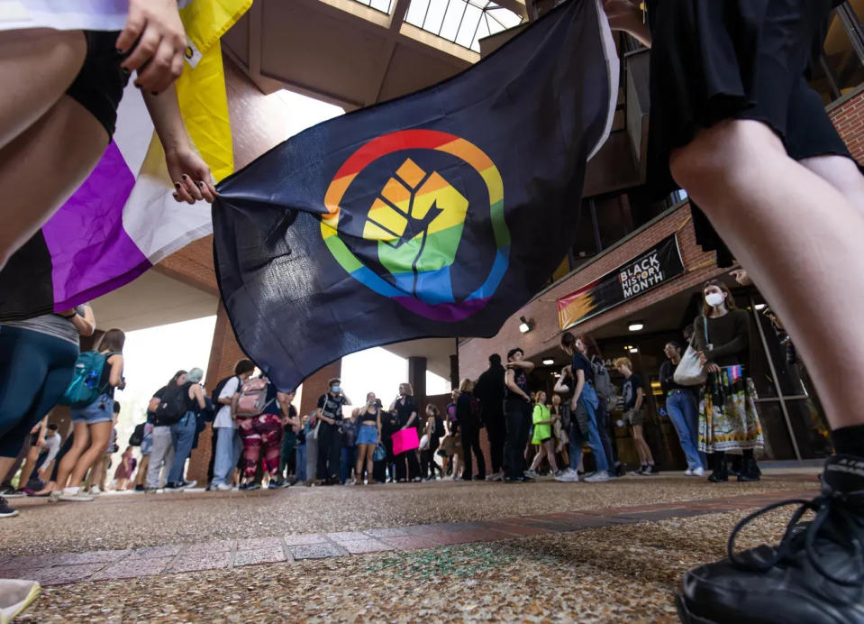 About 100 students at University of Florida, in Gainesville, protest in February 2023 as part of a statewide walkout against Gov. Ron DeSantis' education-related efforts targeting LGBTQ communities and banning DEI, sociology and more.