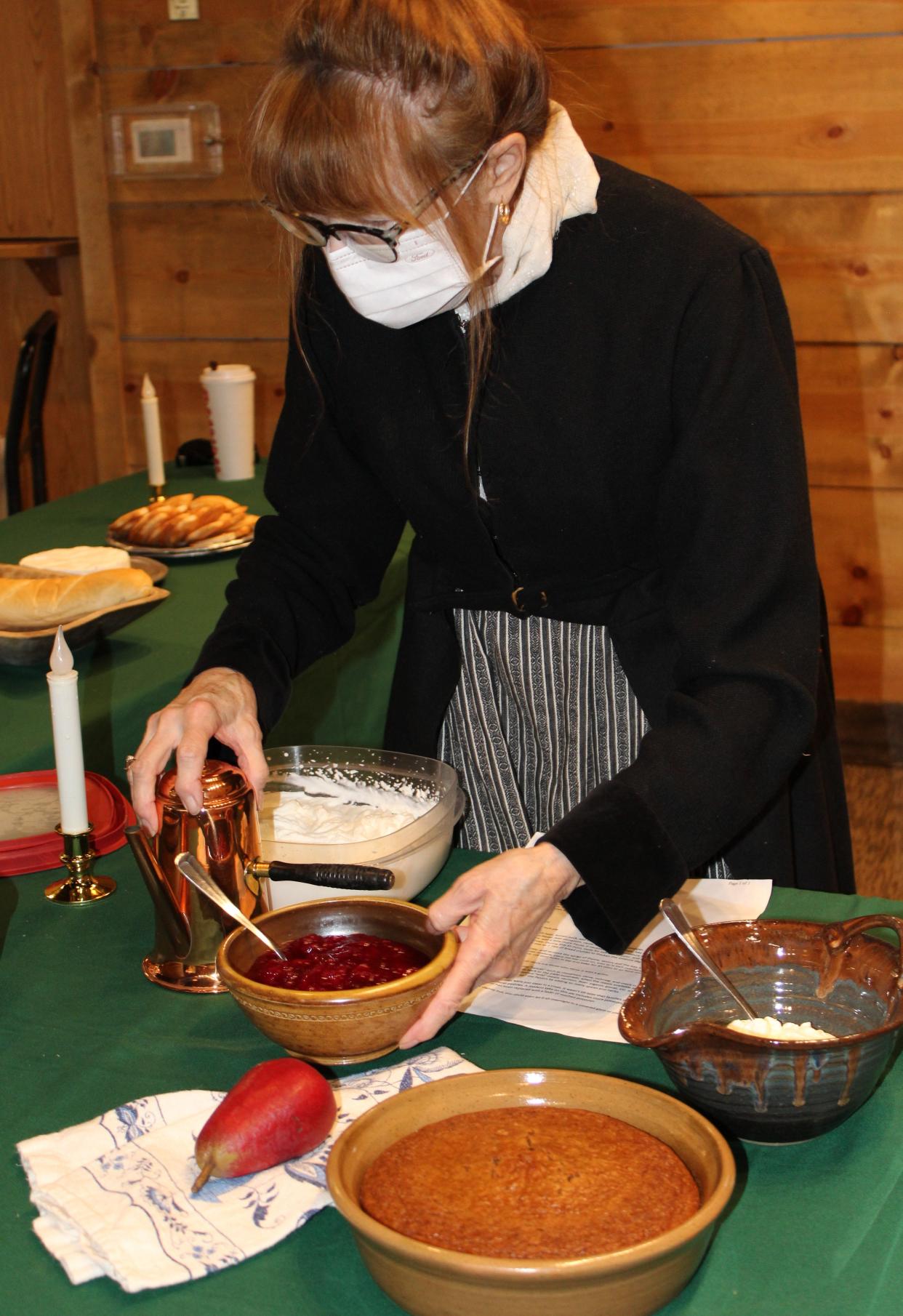 Cathy Taylor of Taylor demonstrates some of the dishes served at Christmas time. After attending mass, French families would eat a special meal to the celebrate the beginning of Christmas day.