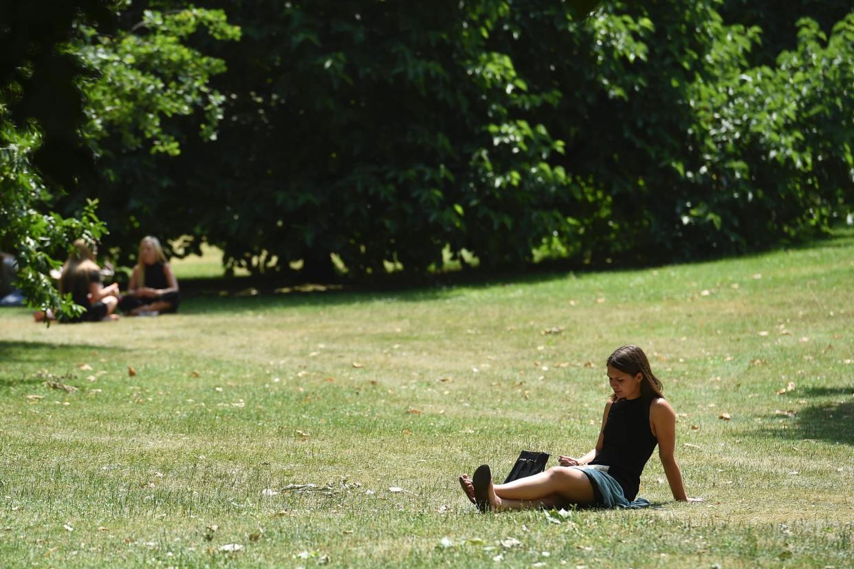 Phew, whata scorcher: a sunbather in St James's Park: AFP/Getty Images