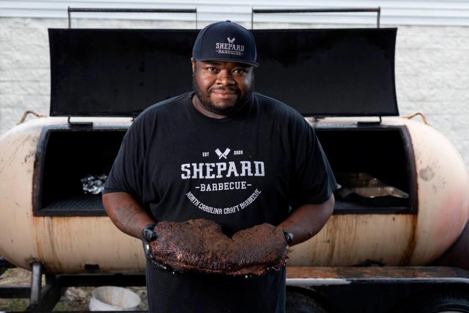 Brandon Shepard, proudly display a perfectly cooked beef brisket from his cooker at his restaurant Shepard Barbecue on Friday September 22, 2023 in Emerald Isle, N.C.