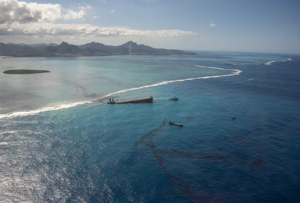 This photo provided by the French Defense Ministry shows oil leaking from the MV Wakashio, a bulk carrier ship that recently ran aground off the southeast coast of Mauritius,, Sunday Aug.9, 2020. The Indian Ocean island of Mauritius has declared a "state of environmental emergency" after the Japanese-owned ship that ran aground offshore days ago began spilling tons of fuel. (Gwendoline Defente/EMAE via AP)