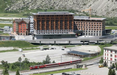 A train of the Gotthard Andermatt Bahnen railways operator stands in front of the Andermatt Swiss Alps resort in Andermatt,