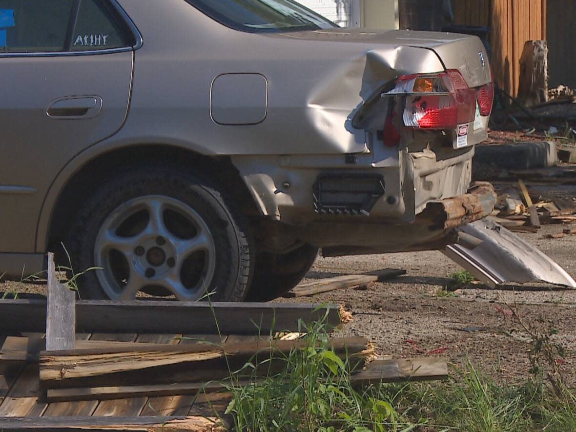 Police say the driver whose truck hit a boy, several parked cars and two fences before hitting a house in Regina on Tuesday morning, was impaired.  (CBC - image credit)