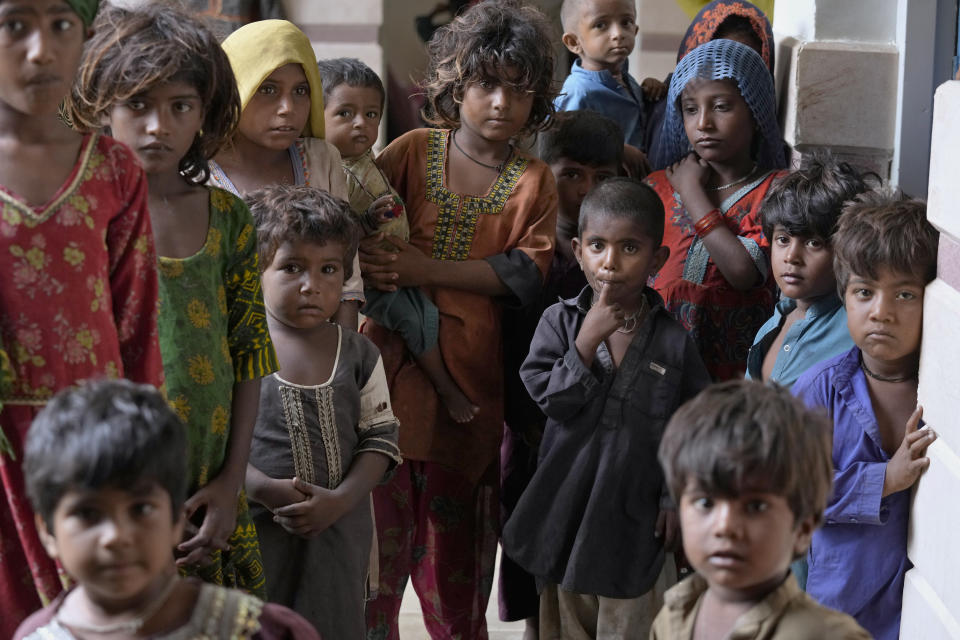 Children gather as they take shelter in a school after fleeing from their villages of costal areas due to Cyclone Biparjoy approaching, in Gharo near Thatta, a Pakistan's southern district in the Sindh province, Wednesday, June 14, 2023. In Pakistan, despite strong winds and rain, authorities said people from vulnerable areas have been moved to safer places in southern Pakistan's districts. With Cyclone Biparjoy expected to make landfall Thursday evening, coastal regions of India and Pakistan are on high alert. (AP Photo/Fareed Khan)