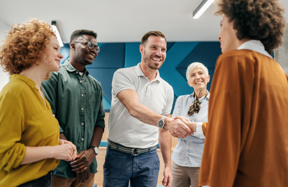 People in a group shaking hands