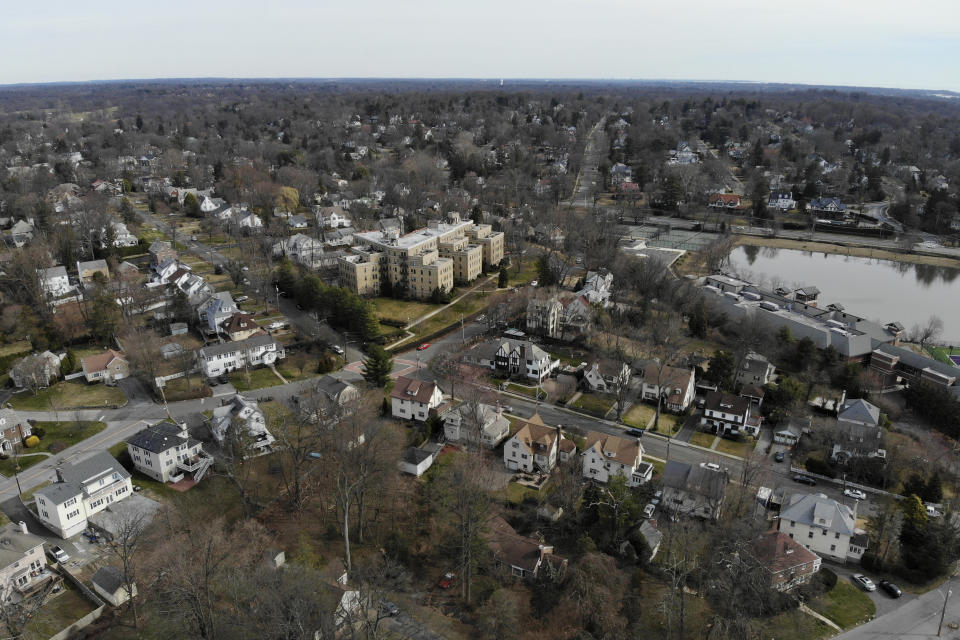 A suburban area that mostly falls within the containment area is seen from the south end of that containment area in New Rochelle, N.Y., Wednesday, March 11, 2020. State officials are shuttering several schools and houses of worship for two weeks in the New York City suburb and sending in the National Guard to help with what appears to be the nation's biggest cluster of coronavirus cases, Gov. Andrew Cuomo said Tuesday. (AP Photo/Seth Wenig)