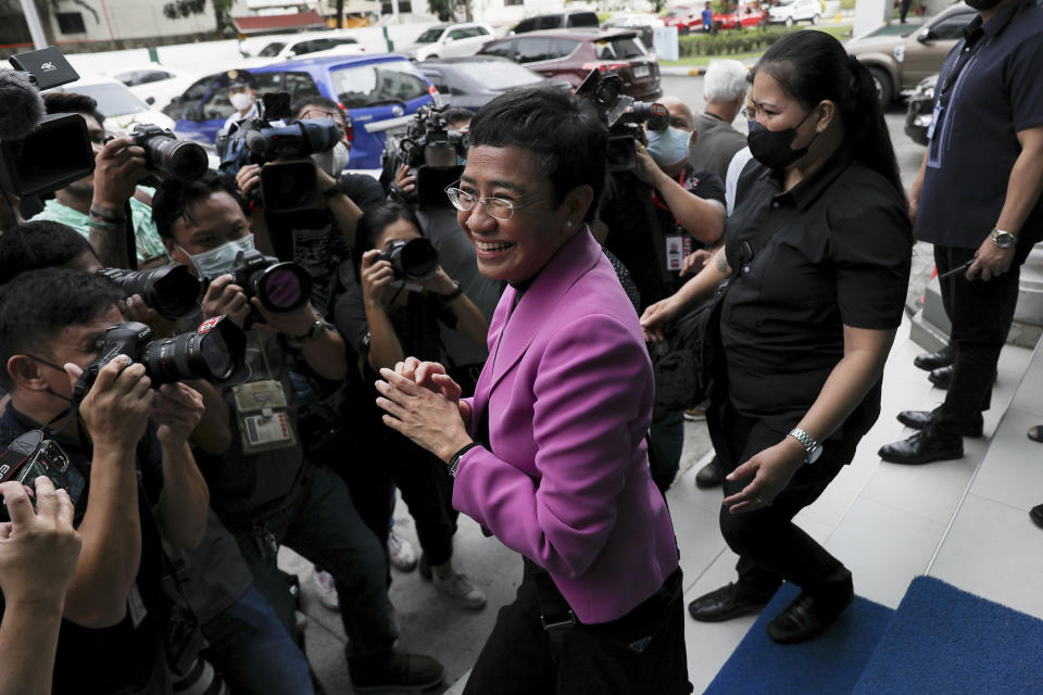 Filipino journalist Maria Ressa, center, one of the winners of the 2021 Nobel Peace Prize and Rappler CEO, leaves after attending a court hearing on tax evasion cases against her at the Court of Tax Appeals in Quezon City, Philippines Wednesday, Jan. 18, 2023. The tax court on Wednesday cleared Ressa and her online news company of tax evasion charges she said were part of a slew of legal cases used by former President Rodrigo Duterte to muzzle critical reporting. (AP Photo/Basilio Sepe)