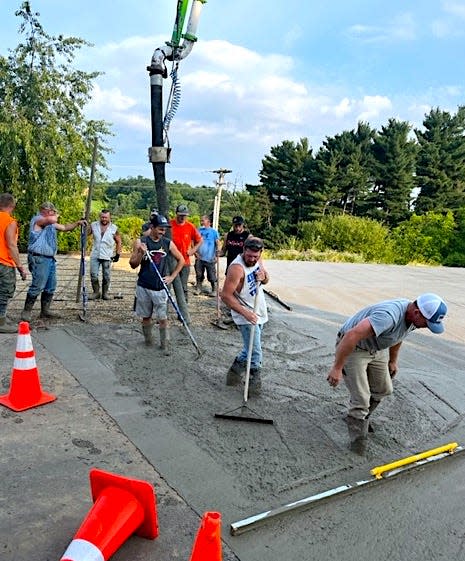 Several Holmes County contractors combined their skills and resources to lay the foundation for the Ashland County West Holmes Career Center house project on the campus of West Holmes High School Wednesday.