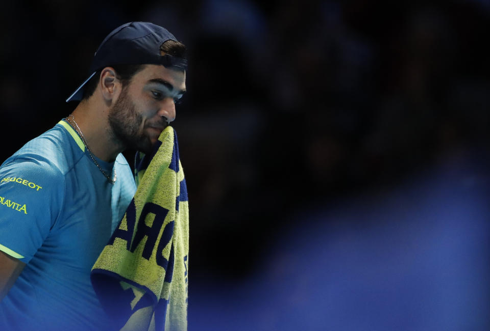 Italy's Matteo Berrettini reacts after dropping a game against Switzerland's Roger Federer during their ATP World Tour Finals singles tennis match at the O2 Arena in London, Tuesday, Nov. 12, 2019. (AP Photo/Alastair Grant)