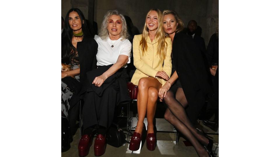 Lila Moss wearing a yellow co-ord at Gucci's Cruise show with Kate Moss, Debbie Harry and Demi Moore 