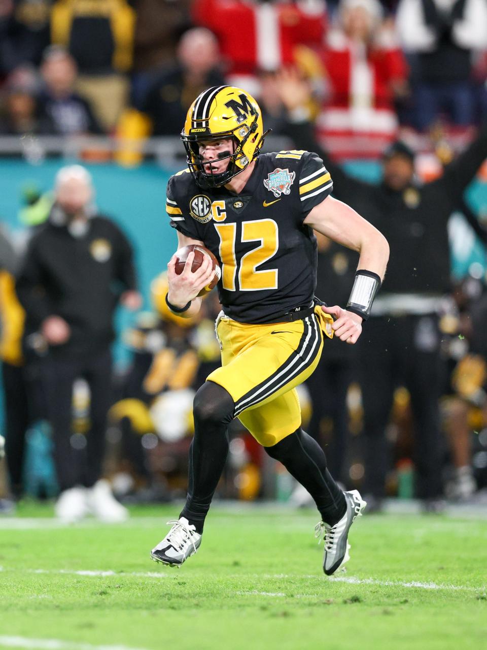 Missouri Tigers quarterback Brady Cook (12) runs with the ball against the Wake Forest Demon Deacons in the second quarter in the 2022 Gasparilla Bowl at Raymond James Stadium.