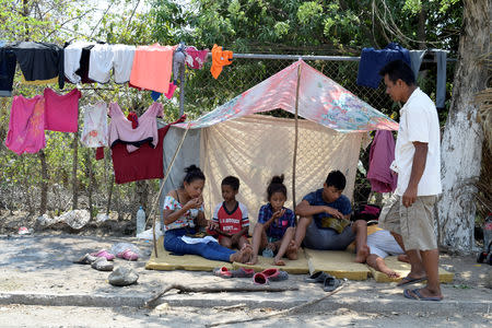 Migrants from Central America rest at a improvised shelter while waiting for their humanitarian visas to cross the country on their way to the United States, in Mapastepec, in Chiapas state, Mexico April 3, 2019. REUTERS/Jose Torres