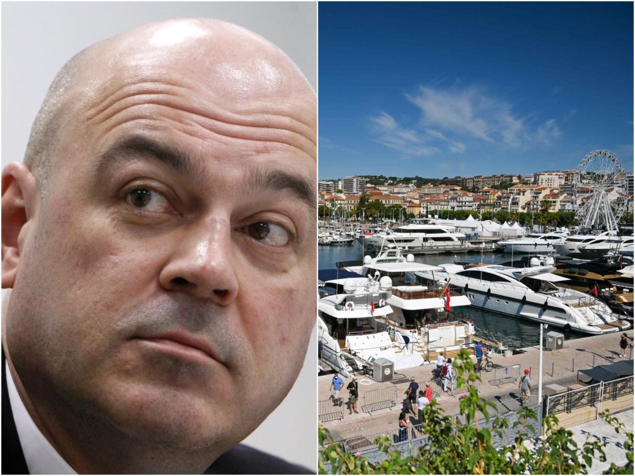 Alexey Kuzmichev next to a picture of Cannes, France
