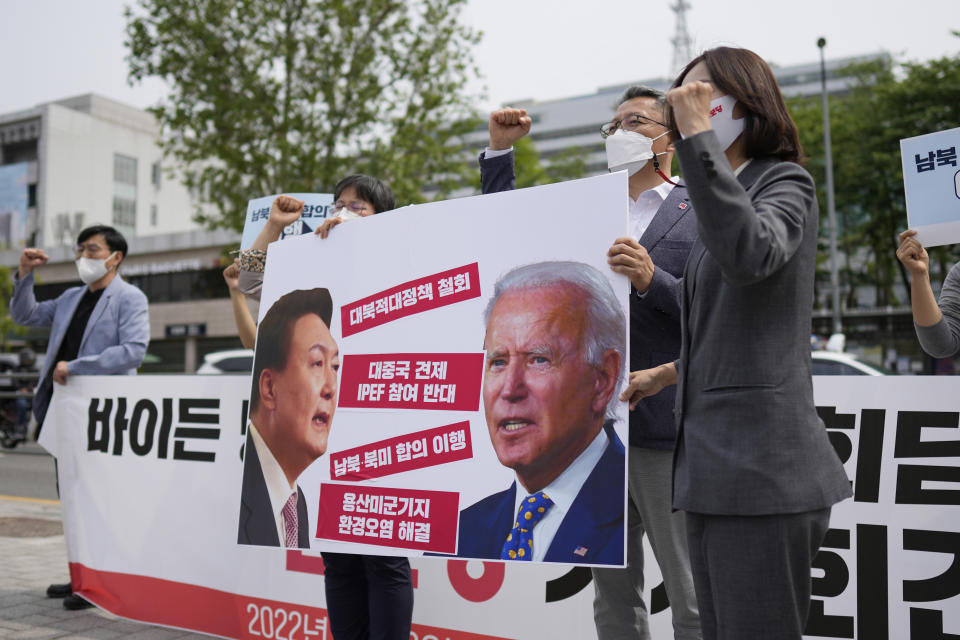 FILE - Members of the Progressive Party shout slogans during a rally demanding the withdrawal the government's anti-North Korea policies near the presidential office in Seoul, South Korea, on May 19, 2022. The letters read "Withdrawal the hostile policies towards North Korea." When the U.S. and South Korean leaders meet Saturday, May 21, North Korea’s nuclear weapons and missile program, already a major focus, may receive extra attention if intelligence predictions of an imminent major weapons demonstration by the North, which is struggling with a COVID-19 outbreak, are right. (AP Photo/Lee Jin-man, File)