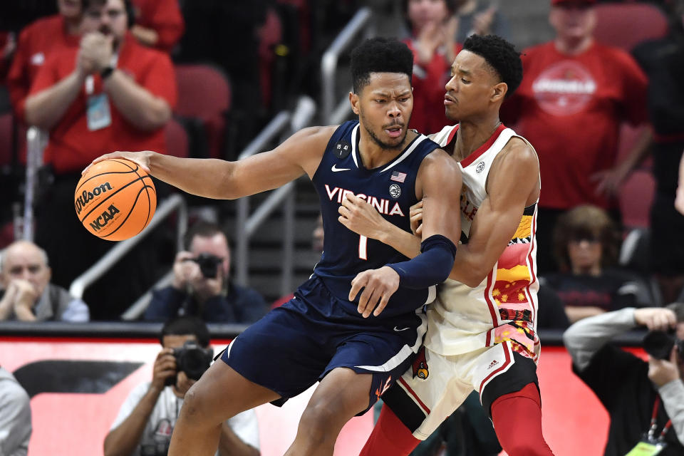 Virginia forward Jayden Gardner (1) backs into the lane against Louisville forward JJ Traynor during the second half of an NCAA college basketball game in Louisville, Ky., Wednesday, Feb. 15, 2023. Virginia won 61-58. (AP Photo/Timothy D. Easley)