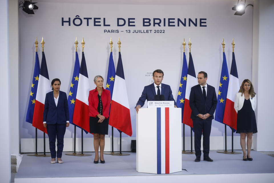 French President Emmanuel Macron, center, flanked by Defense Minister Sebastien Lecornu, second right, and Prime Minister Elisabeth Borne, second left, delivers his speech to militaries on the eve of Bastille Day, Wednesday, July 13, 2022 at the Defense Minister's residence in Paris. France will celebrates its national holidays Thursday with thousands of French and allies from Eastern Europe troops surrounded by planes, vehicles, and a drone, to highlight France's military efforts to support Ukraine. (AP Photo/Thomas Padilla, Pool)