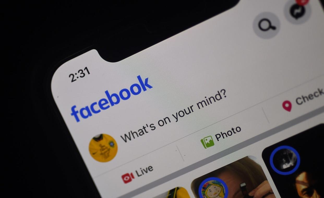  Facebook feed page is displayed on a smartphone 