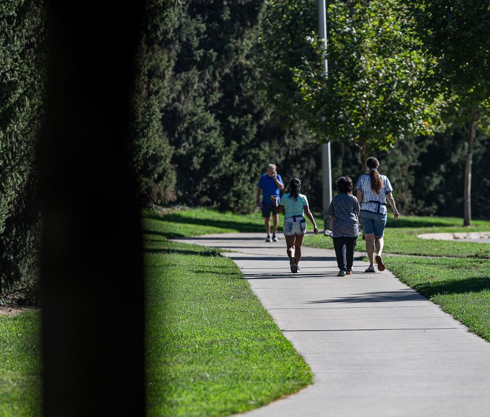 A family hiked along the waterfront at the Labor Day Hike, Bike & Paddle at Waterfront Park in Louisville, Ky. on Monday, Sept. 4, 2023.