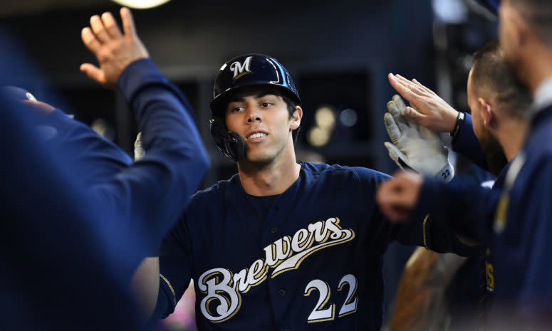 Christian Yelich celebrating in the dugout with his teammates.