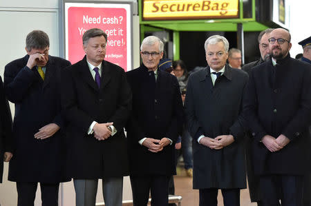 Belgium's Minister of Interior Jan Jambon (L), Belgium's Prime Minister Charles Michel (R), and officials attend a ceremony at Brussels Zaventem airport, commemorating the second anniversary of twin attacks at Brussels airport and a metro train in Brussels, Belgium March 22, 2018. REUTERS/Eric Vidal