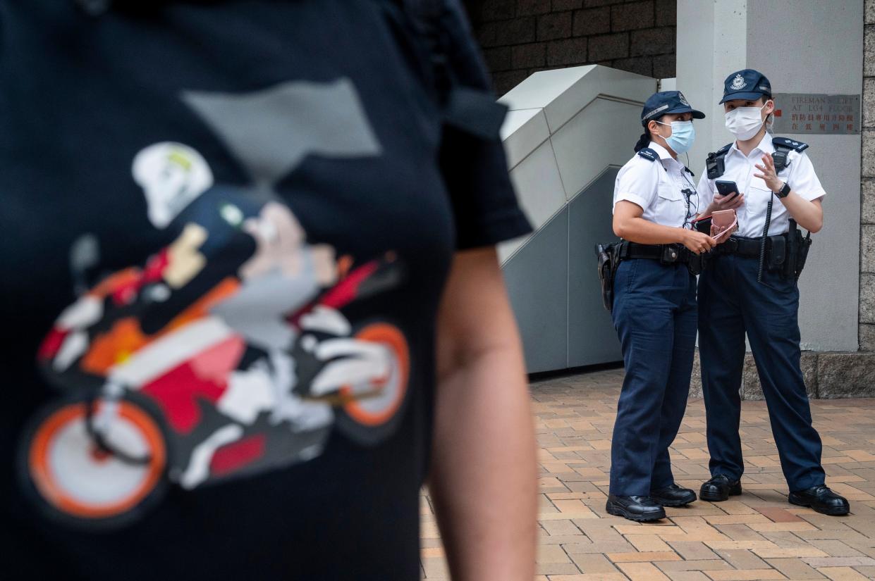  A person (L), wearing a shirt in support of convicted Tong Ying-kit, stands outside the High Court in Hong Kong, China, 27 July 2021. Tong Ying-kit, 24, is the first defendant to be found guilty for secession and terrorism under the Beijing-imposed national security law  (EPA)