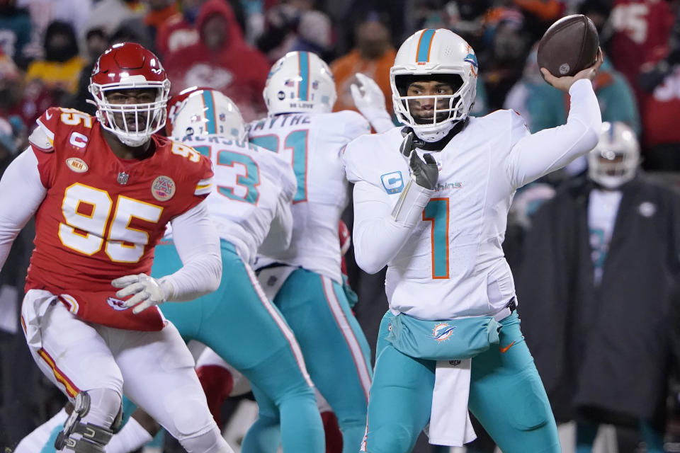 Miami Dolphins quarterback Tua Tagovailoa (1) passes against the Kansas City Chiefs during the first half of an NFL wild-card playoff football game Saturday, Jan. 13, 2024, in Kansas City, Mo. (AP Photo/Ed Zurga)