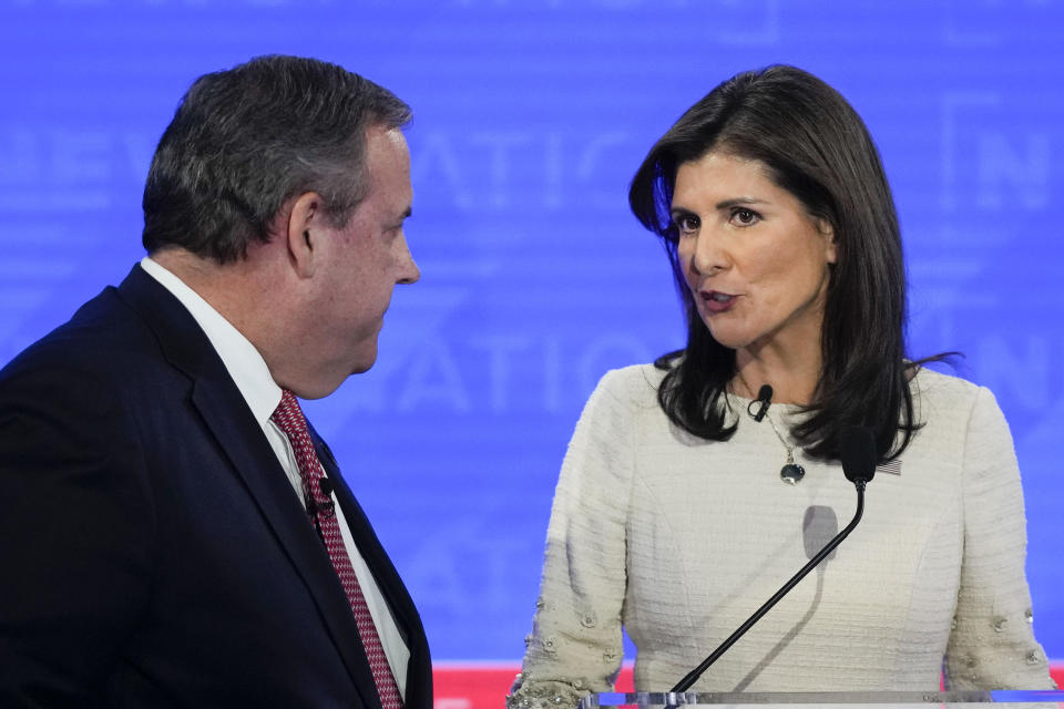 Republican presidential candidates, former New Jersey Gov. Chris Christie, left, talking with former U.N. Ambassador Nikki Haley, right, during a commercial break at a Republican presidential primary debate on Wednesday, Dec. 6, 2023. / Credit: Gerald Herbert / AP