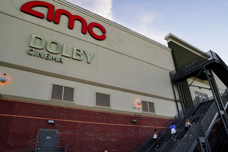 FILE PHOTO: Three women use the emergency exit stairs of an AMC movie theater as a makeshift gym in Smyrna