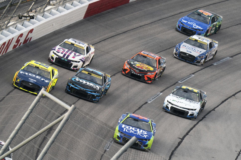 Erik Jones (43), Ross Chastain (1), Ryan Blaney (12), Alex Bowman (48), Martin Truex (19), Kevin Harvick (4) and Ricky Stenhouse Jr. (47) compete in the NASCAR Southern 500 auto race Sunday, Sept. 4, 2022, in Darlington, S.C. Jones won the race after taking the lead from Kyle Busch when Busch blew a motor with 30 laps remaining in the race. (AP Photo/Sean Rayford)