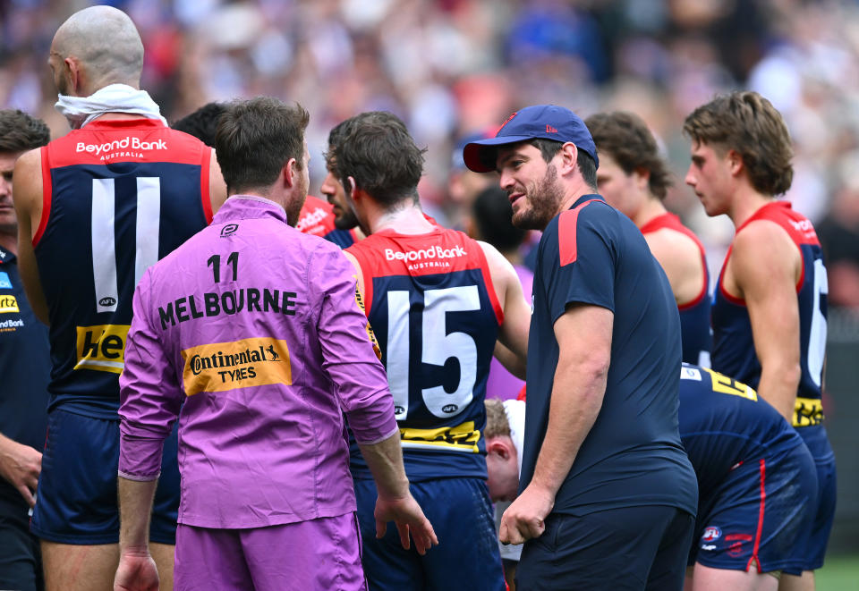 MELBOURNE, AUSTRALIA - MARCH 17:  Angus Brayshaw of the Demons talks to players in the huddle during the round one Demons AFL match between Melbourne Demons and Western Bulldogs at Melbourne Cricket Ground, on March 17, 2024, in Melbourne, Australia. (Photo by Quinn Rooney/Getty Images)