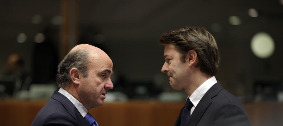 French Finance Minister Francois Baroin, right, speaks with Spain's Economy Minister Luis de Guindos during a meeting of EU finance ministers at the EU Council building in Brussels on Tuesday, March 13, 2012. The decision to give Spain some more leeway on cutting this year's deficit is already triggering demands for more fiscal leniency for other European countries. Finance ministers from the eurozone said Monday that Spain will be allowed to run a deficit of 5.3 percent of gross domestic product this year, above the original 4.4 percent target. (AP Photo/Virginia Mayo)