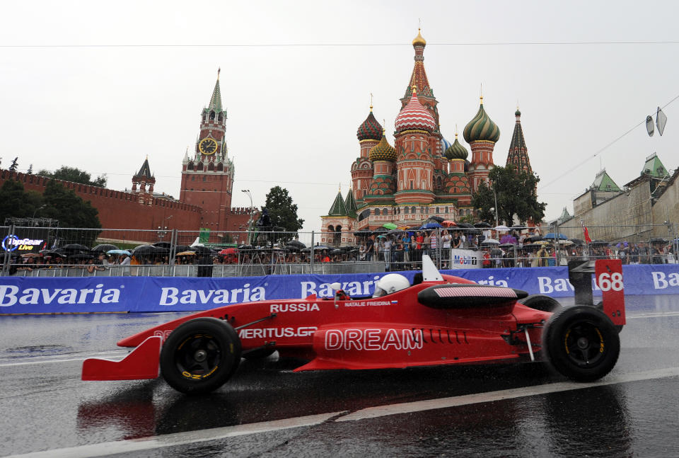 Russia's racing driver Natalie Freidina drives past St. Basils cathedral during the "Moscow City Racing" show on July 17, 2011 in central Moscow. AFP PHOTO / NATALIA KOLESNIKOVA (Photo credit should read NATALIA KOLESNIKOVA/AFP/Getty Images)
