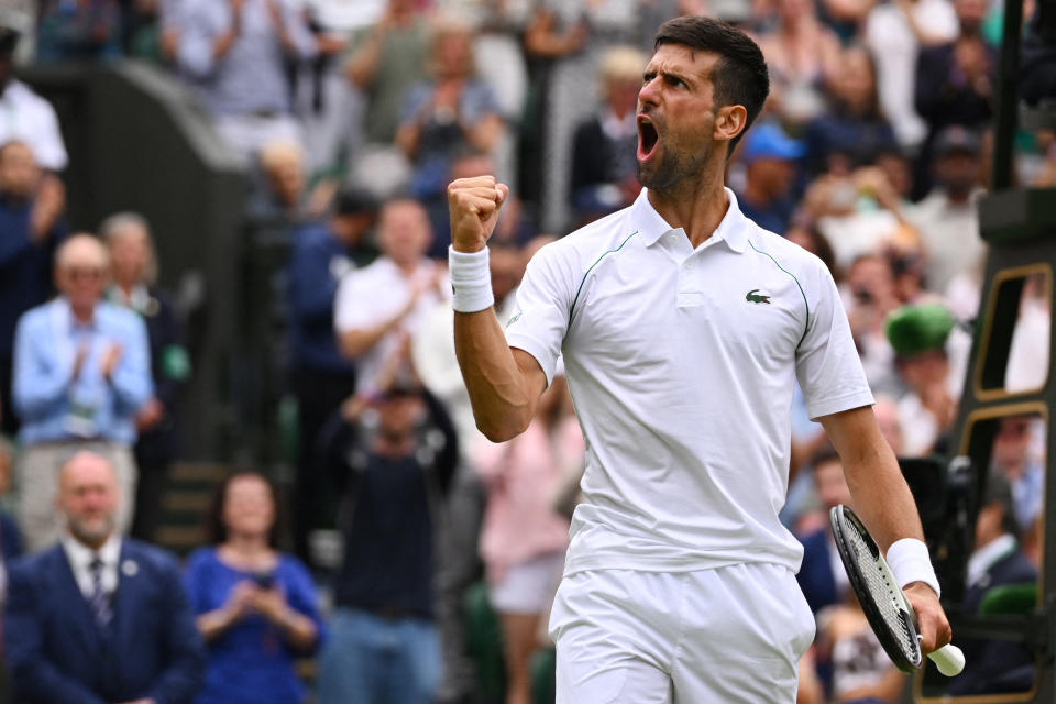 Serbia's Novak Djokovic celebrates winning against Italy's Jannik Sinner during their men's singles quarter final tennis match on the ninth day of the 2022 Wimbledon Championships at The All England Tennis Club in Wimbledon, southwest London, on July 5, 2022. - RESTRICTED TO EDITORIAL USE (Photo by SEBASTIEN BOZON / AFP) / RESTRICTED TO EDITORIAL USE (Photo by SEBASTIEN BOZON/AFP via Getty Images)