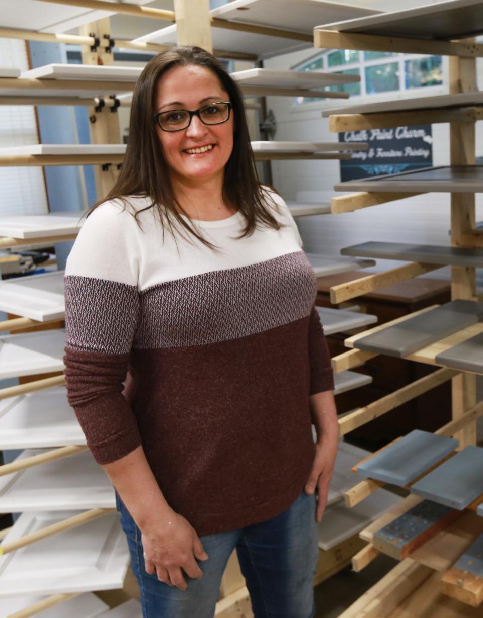 Maria Viveiros Ferreira, owner of Everlasting Charm Cabinetry & Furniture Refinishing, working in her shop on Thursday, April 28, 2022.