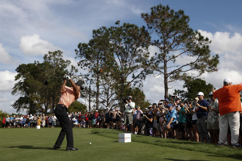 Tiger Woods tees off on the third hole during the first round of the PNC Championship golf tournament Saturday, Dec. 18, 2021, in Orlando, Fla. (AP Photo/Scott Audette)