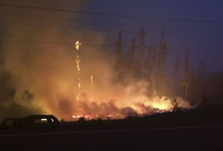 Firefighters tackle a wildfire near the town of La Ronge, Saskatchewan July 4, 2015 in a picture provided by the Saskatchewan Ministry of Government Relations. REUTERS/Saskatchewan Ministry of Government Relations/Handout via Reuters