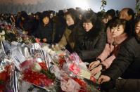 North Koreans offer flowers at Mansudae in Pyongyang in this picture taken and provided by Kyodo on December 16, 2013, on the eve of the second death anniversary of former leader Kim Jong Il. (REUTERS/Kyodo)