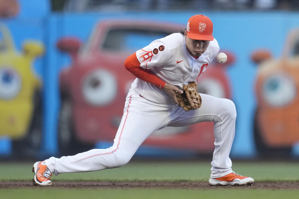 San Francisco Giants third baseman Wilmer Flores makes an error on a ground ball hit by Tampa Bay Rays' Isaac Paredes during the third inning of a baseball game in San Francisco, Tuesday, Aug. 15, 2023. (AP Photo/Jeff Chiu)