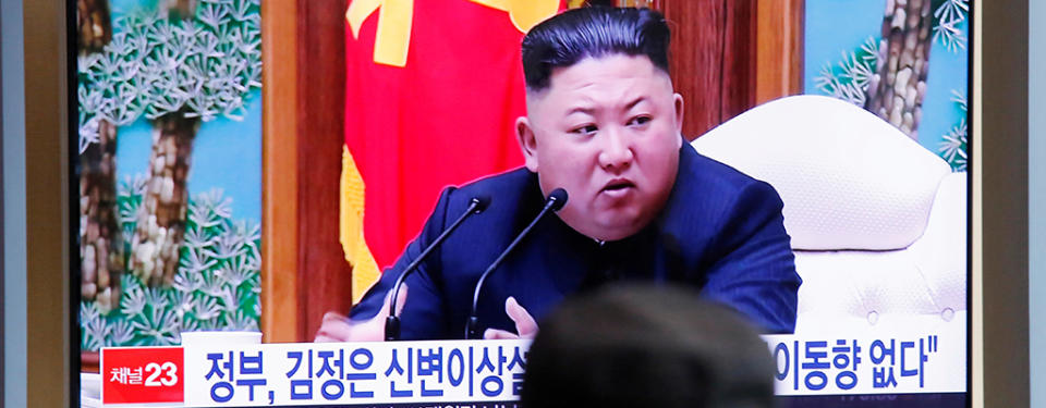 FILE PHOTO: South Korean people watch a TV broadcasting a news report on North Korean leader Kim Jong Un in Seoul, South Korea, April 21, 2020. REUTERS/Heo Ran/File Photo