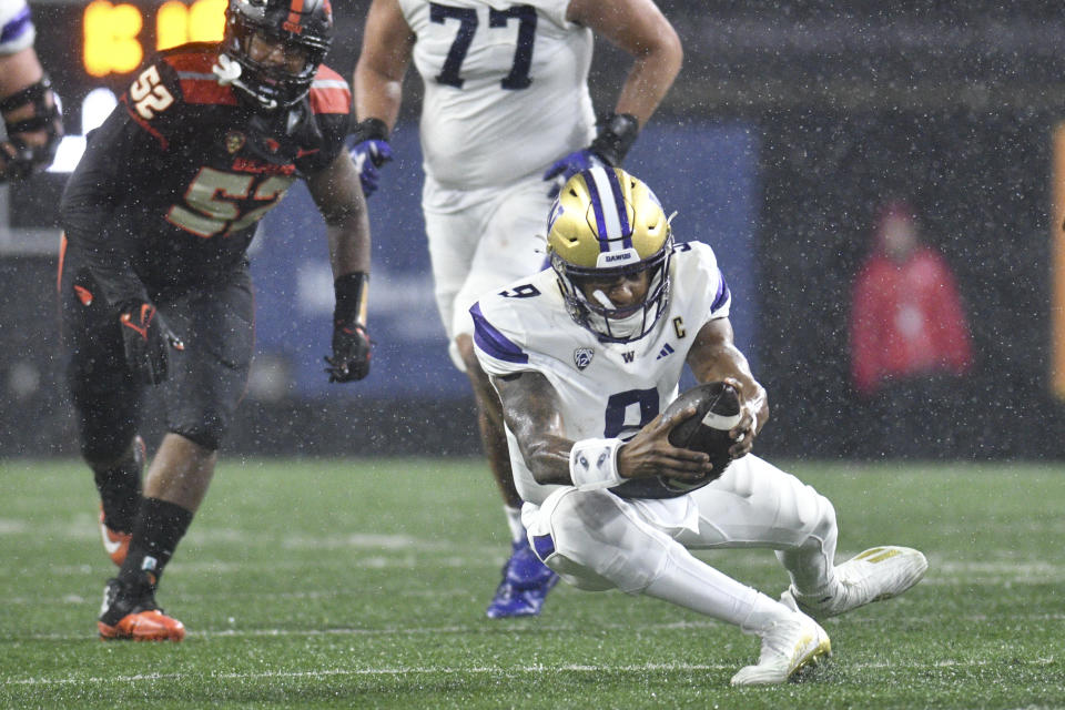 Washington quarterback Michael Penix Jr. (9) dives for a first down against Oregon State during the first half of an NCAA college football game Saturday, Nov. 18, 2023, in Corvallis, Ore. (AP Photo/Mark Ylen)