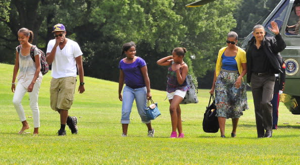 Malia Obama; Avery Robinson (the Obamas' nephew); Roxanne Nesbitt (daughter of family friends, Marty Nesbitt and Anita Blanchard); Sasha Obama; first lady Michelle Obama; and President Obama walk across the South Lawn of the White House August 7, 2011 in Washington, D.C. The first family was returning from a weekend at Camp David, the presidential retreat near Thurmont, Maryland.. (Photo by Ron Sachs-Pool/Getty Images)