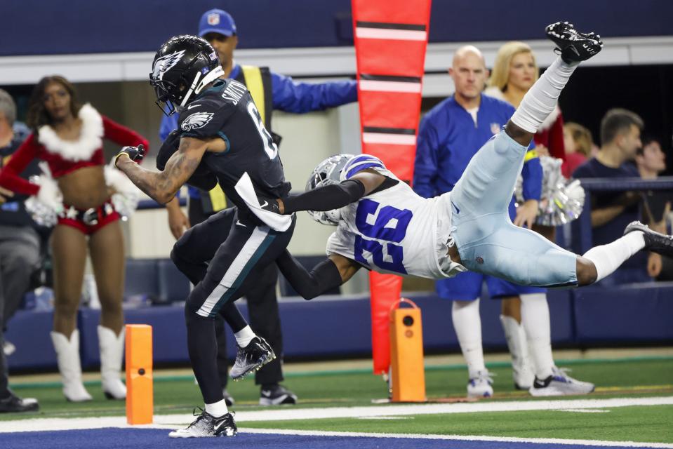 Philadelphia Eagles' DeVonta Smith catches a touchdown pass with Dallas Cowboys' DaRon Bland defending during the second half of an NFL football game Saturday, Dec. 24, 2022, in Arlington, Texas. (AP Photo/Michael Ainsworth)