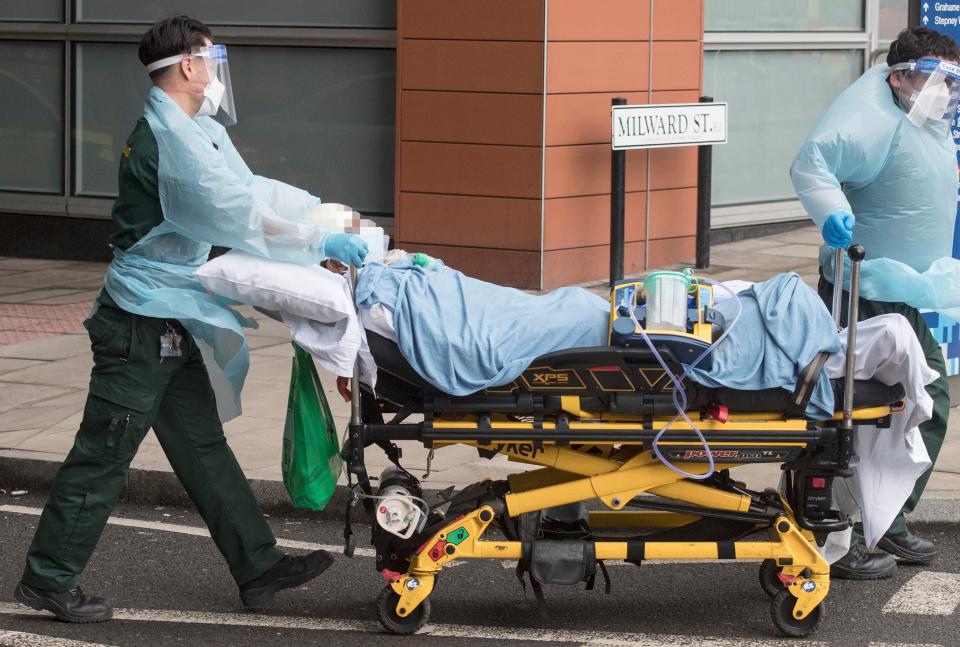 A patient is taken to an ambulance outside London hospital during England's third national lockdown to curb the spread of coronavirus.PA