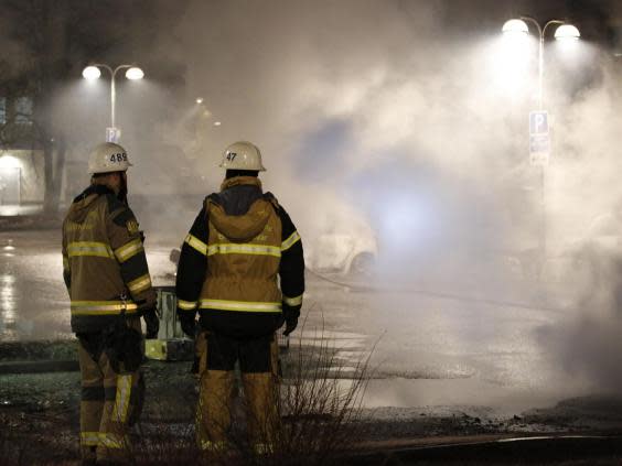 Several cars were set alight in Rinkeby two days after Trump referenced an incident of refugee violence in the district that never actually happened (AFP/Getty Images)