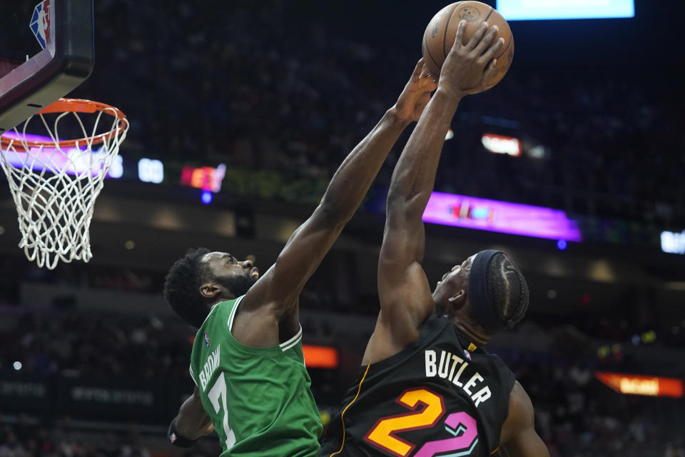 Boston Celtics guard Jaylen Brown (7) blocks a shot to the basket by Miami Heat forward Jimmy Butler (22) during the first half of an NBA basketball game, Thursday, Nov. 4, 2021, in Miami. (AP Photo/Marta Lavandier)