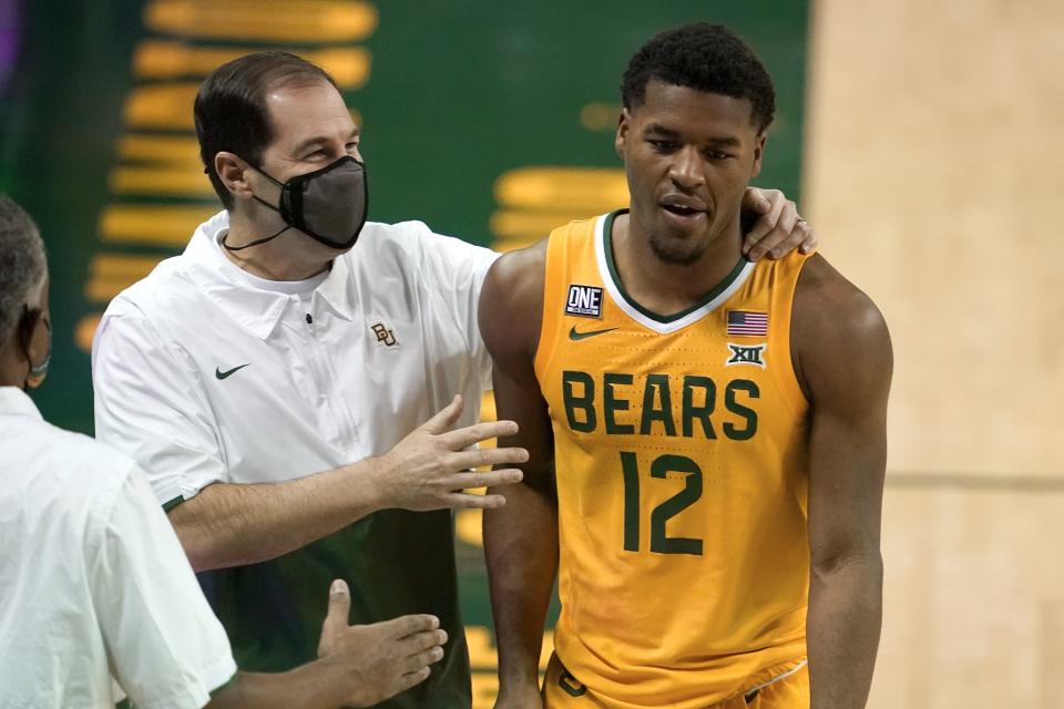 Baylor head coach Scott Drew, left, talks with guard Jared Butler (12) as he leaves the game late in the second half of an NCAA college basketball game against Stephen F. Austin in Waco, Texas, Wednesday, Dec. 9, 2020.