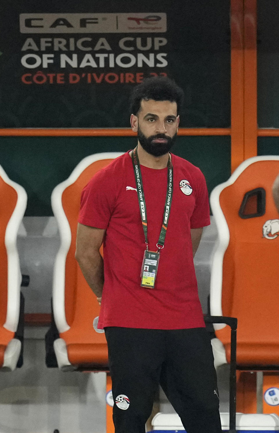 Egypt's injured player Mohamed Salah watches his team mates warm up before the African Cup of Nations Group B soccer match between Cape Verde and Egypt at the Felix Houphouet Boigny stadium in Abidjan, Ivory Coast, Monday, Jan. 22, 2024. (AP Photo/Themba Hadebe)